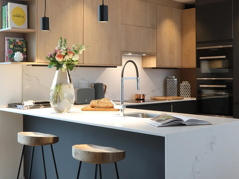 Sleek modern kitchen design, chairs, tap and worktop